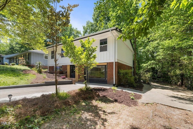 2904 Sprucewood Dr, Durham, NC 27707 - view of front of home with brick siding and board and batten siding