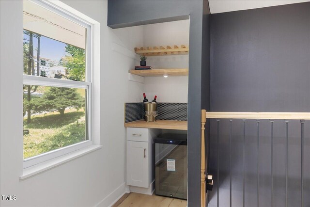 2904 Sprucewood Dr, Durham, NC 27707 - washroom featuring baseboards, plenty of natural light, a dry bar, and wine cooler