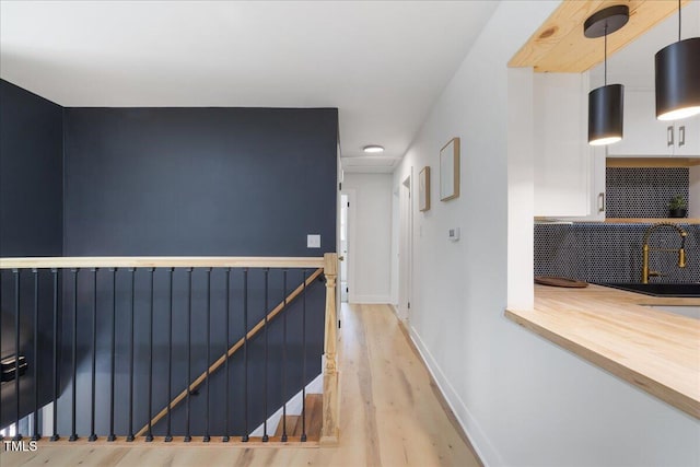 2904 Sprucewood Dr, Durham, NC 27707 - hall featuring baseboards, an upstairs landing, and wood finished floors