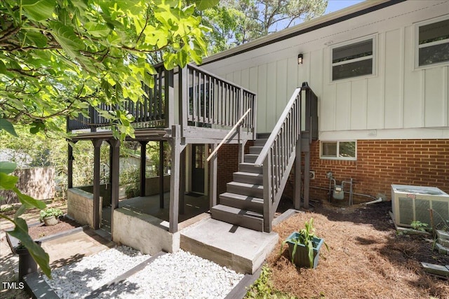 2904 Sprucewood Dr, Durham, NC 27707 - entrance to property with board and batten siding, brick siding, cooling unit, and a wooden deck