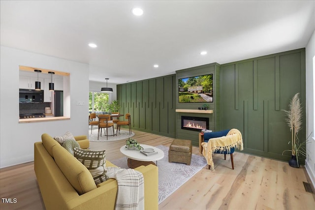 2904 Sprucewood Dr, Durham, NC 27707 - living room featuring recessed lighting, baseboards, light wood-type flooring, and a fireplace