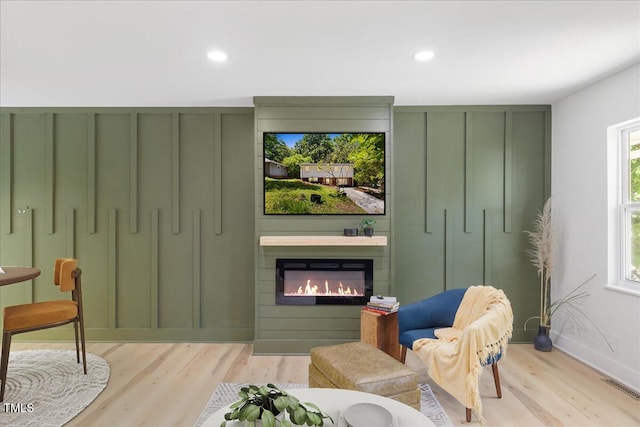 2904 Sprucewood Dr, Durham, NC 27707 - sitting room featuring light wood-style floors, a glass covered fireplace, recessed lighting, and visible vents