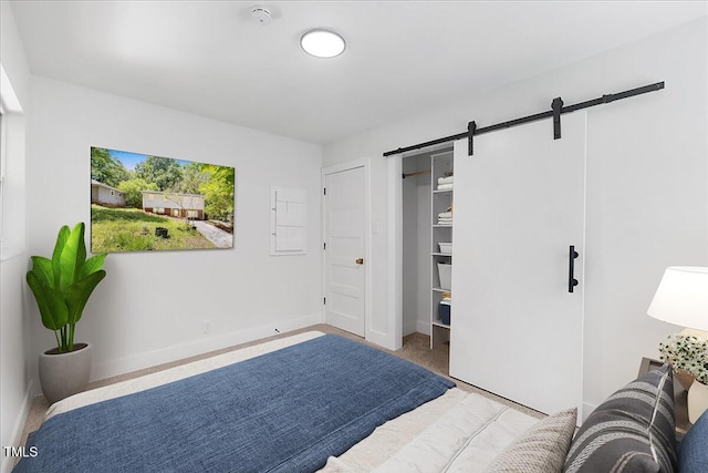 2904 Sprucewood Dr, Durham, NC 27707 - carpeted bedroom with baseboards and a barn door