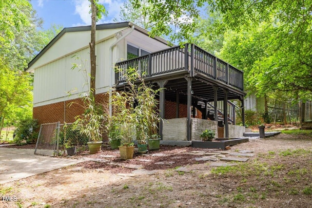 2904 Sprucewood Dr, Durham, NC 27707 - view of property exterior featuring brick siding, a wooden deck, and stairs