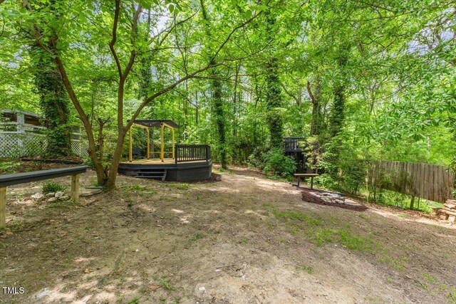 2904 Sprucewood Dr, Durham, NC 27707 - view of yard with a deck, fence, and a fire pit