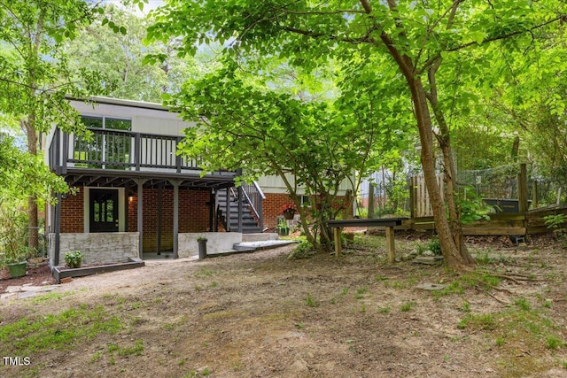 2904 Sprucewood Dr, Durham, NC 27707 - rear view of property featuring brick siding, fence, a wooden deck, and stairs