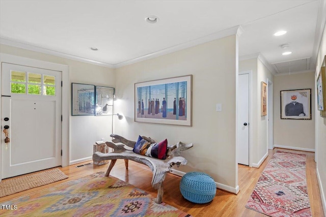 foyer entrance featuring visible vents, crown molding, light wood-type flooring, baseboards, and recessed lighting