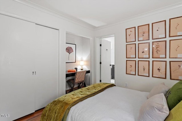 bedroom with ornamental molding and dark wood finished floors