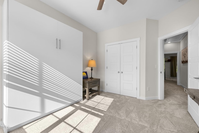bedroom featuring ceiling fan, carpet floors, attic access, baseboards, and a closet