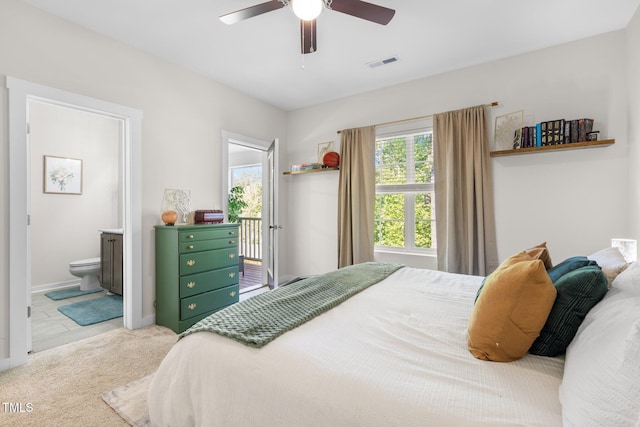 bedroom with ceiling fan, ensuite bath, carpet floors, baseboards, and visible vents
