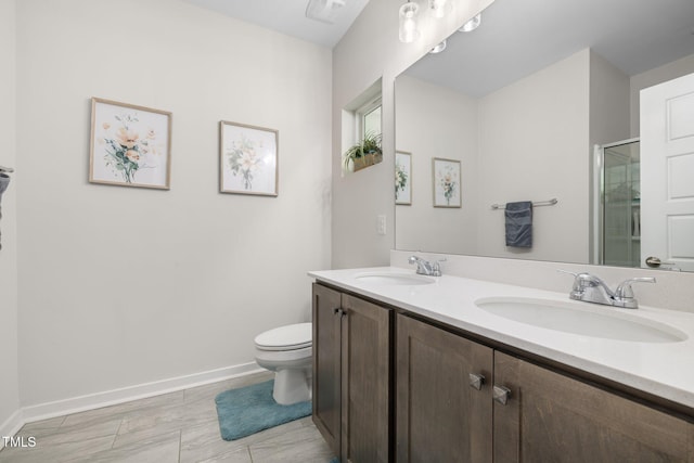 bathroom featuring a sink, baseboards, a shower stall, and double vanity
