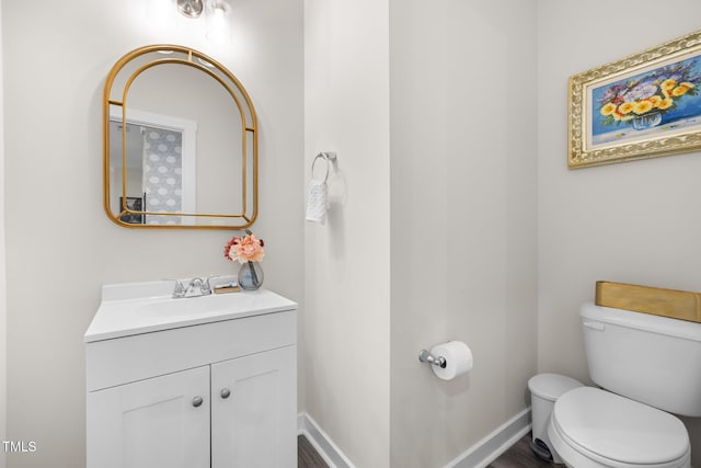 half bathroom with vanity and toilet