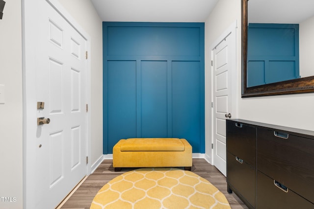sitting room with baseboards and wood finished floors