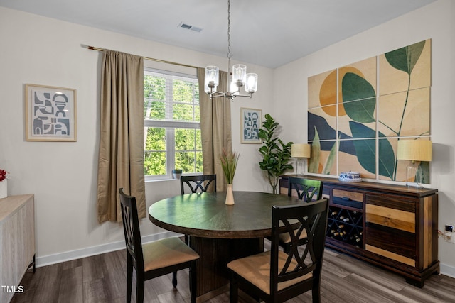 dining area with plenty of natural light, a notable chandelier, wood finished floors, and visible vents