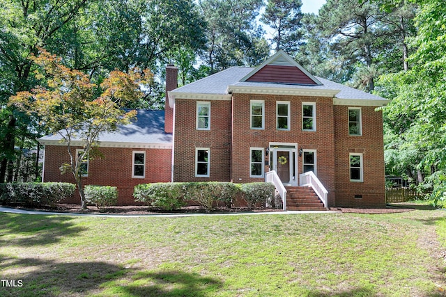 5304 W Oaks Dr, Fuquay Varina, NC 27526 - view of front facade with a chimney, a front yard, and brick siding