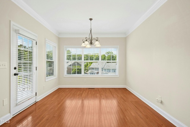 unfurnished dining area with an inviting chandelier, baseboards, and light wood-style flooring