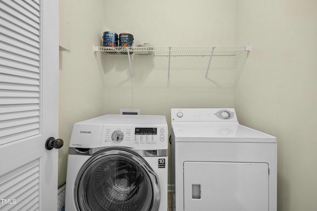 clothes washing area with washer and dryer and laundry area