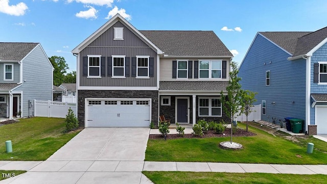 view of front of home with board and batten siding, driveway, a garage, and stone siding