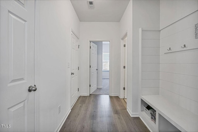 mudroom featuring dark wood finished floors and baseboards