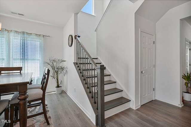 stairway featuring wood finished floors and baseboards