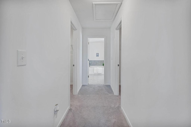 corridor with light colored carpet and baseboards