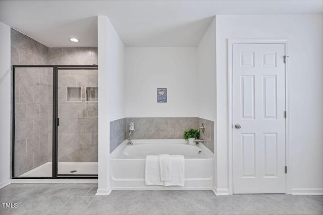 full bath with a stall shower, a bath, tile patterned flooring, and baseboards