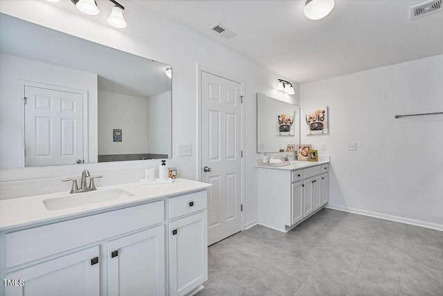 bathroom with two vanities and baseboards