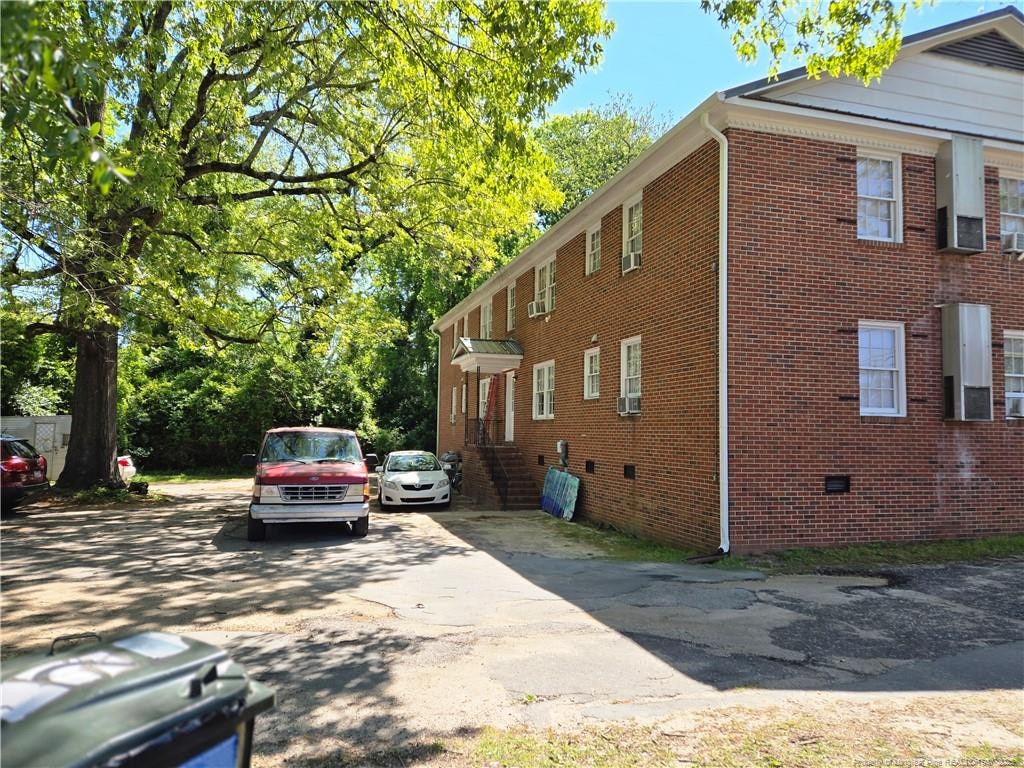 view of property exterior with brick siding, crawl space, and cooling unit