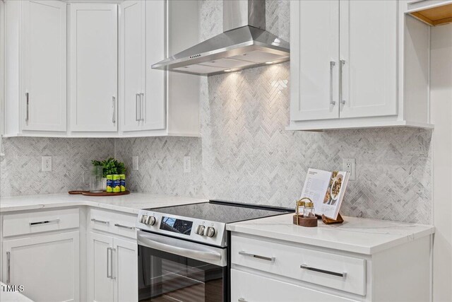 596 Oaks Lane Rd, Timberlake, NC 27583 - kitchen with white cabinetry, stainless steel electric range, decorative backsplash, and wall chimney exhaust hood