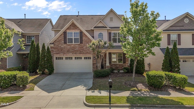 view of front of house featuring an attached garage, board and batten siding, stone siding, and concrete driveway