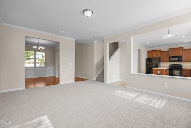 unfurnished living room with an inviting chandelier, ornamental molding, stairs, and light carpet