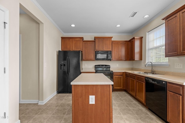 kitchen with visible vents, crown molding, a center island, a sink, and black appliances