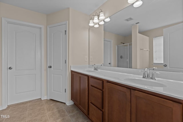 full bathroom with double vanity, a sink, tile patterned flooring, and a shower stall