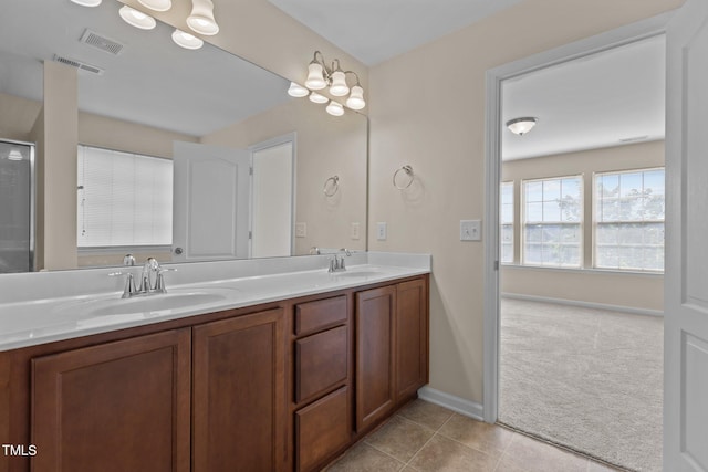 bathroom with visible vents, a sink, and double vanity