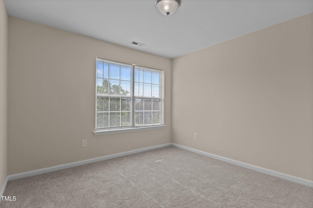 carpeted empty room with baseboards and visible vents