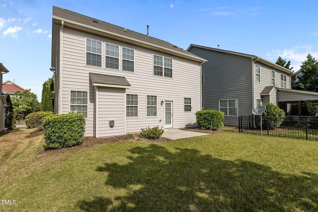 rear view of property with a lawn and fence