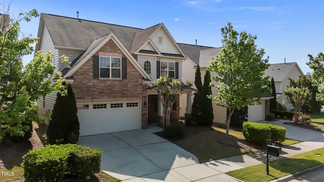 view of front of home with an attached garage, a shingled roof, and driveway