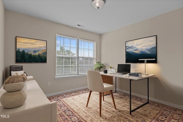 home office featuring baseboards and visible vents