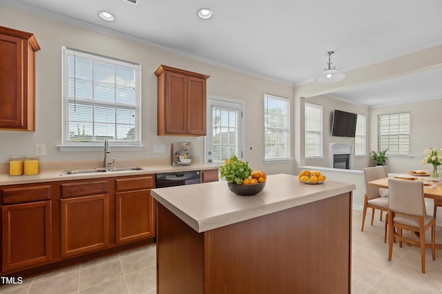 kitchen with plenty of natural light, ornamental molding, a sink, and a fireplace