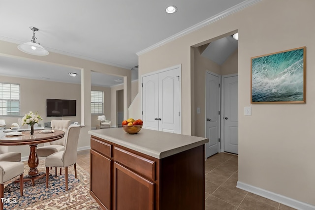 kitchen featuring light countertops, tile patterned floors, open floor plan, and crown molding