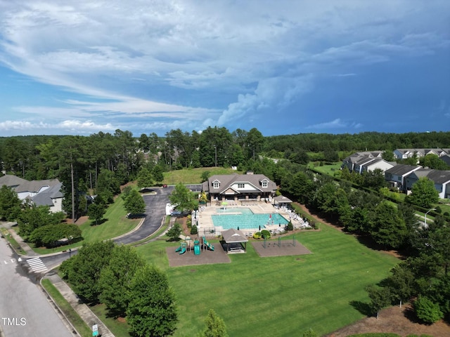 birds eye view of property featuring a view of trees