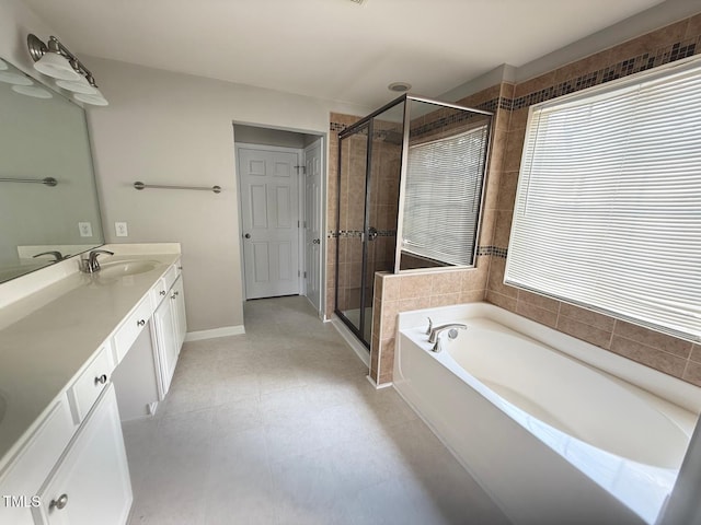 110 Bristolwood Cir, Morrisville, NC 27560 - full bathroom featuring vanity, a garden tub, a shower stall, and baseboards
