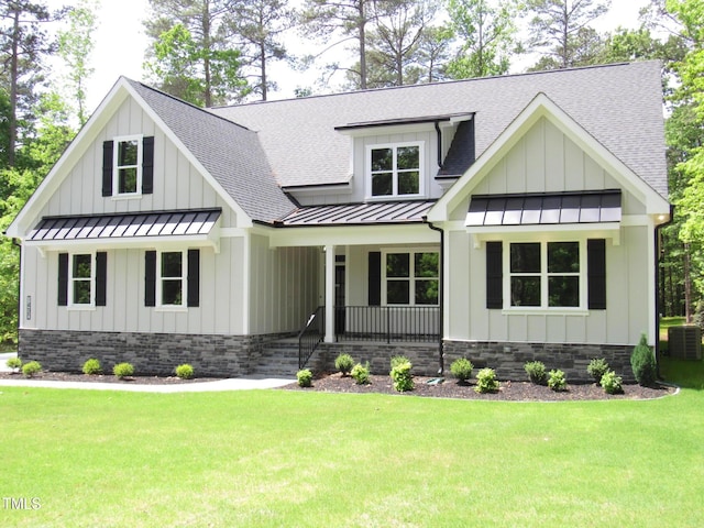 modern inspired farmhouse featuring a standing seam roof, covered porch, board and batten siding, and roof with shingles