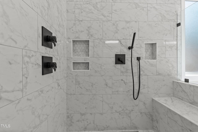 full bath with tiled shower