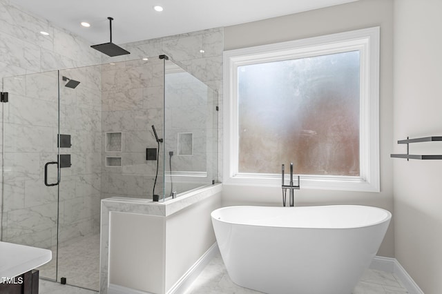 bathroom with marble finish floor, recessed lighting, a freestanding tub, baseboards, and a shower stall
