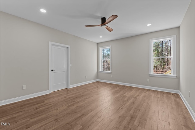 unfurnished room with a ceiling fan, baseboards, recessed lighting, and wood finished floors