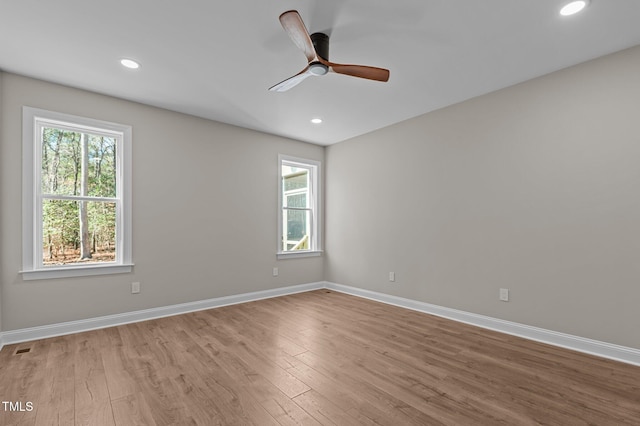 empty room featuring a ceiling fan, baseboards, recessed lighting, and wood finished floors