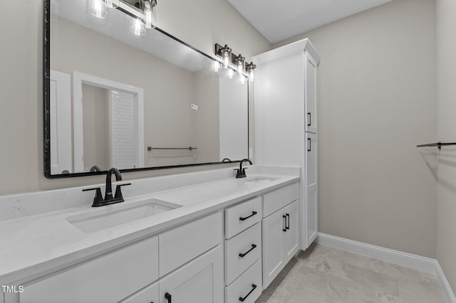 full bath featuring a sink, baseboards, and marble finish floor