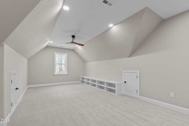 additional living space with visible vents, carpet floors, baseboards, ceiling fan, and vaulted ceiling
