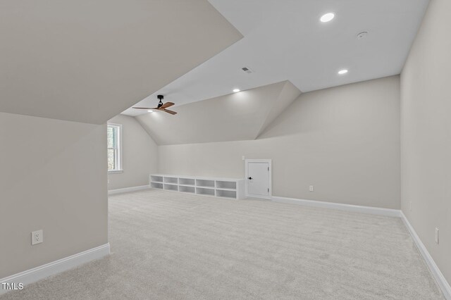 bonus room featuring carpet flooring, baseboards, vaulted ceiling, and ceiling fan